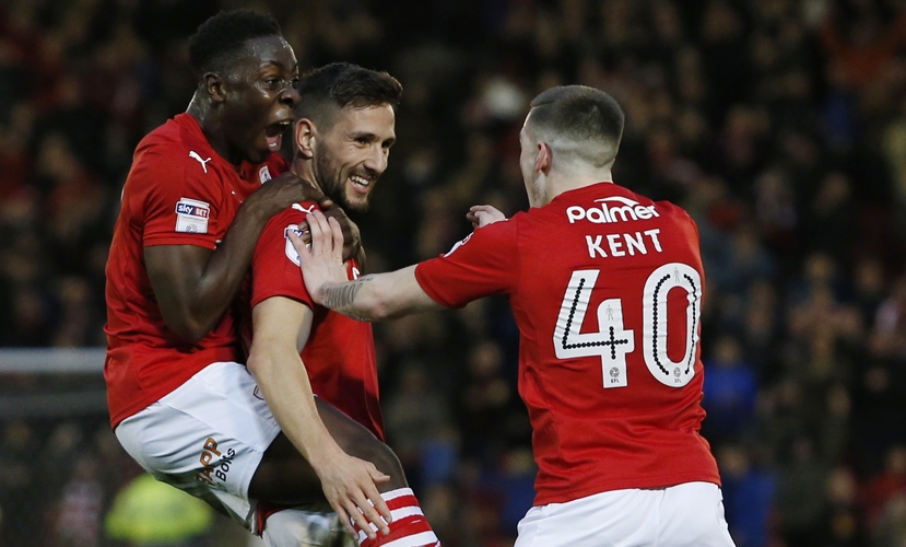 Barnsley's Conor Hourihane (C) celebrates with Andy Yiadom (L) and Ryan Kent